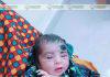 ভুট্টার ক্ষেতে পাওয়া নবজাতকের পাশে দাড়ালেন এক বয়স্ক মহিলা